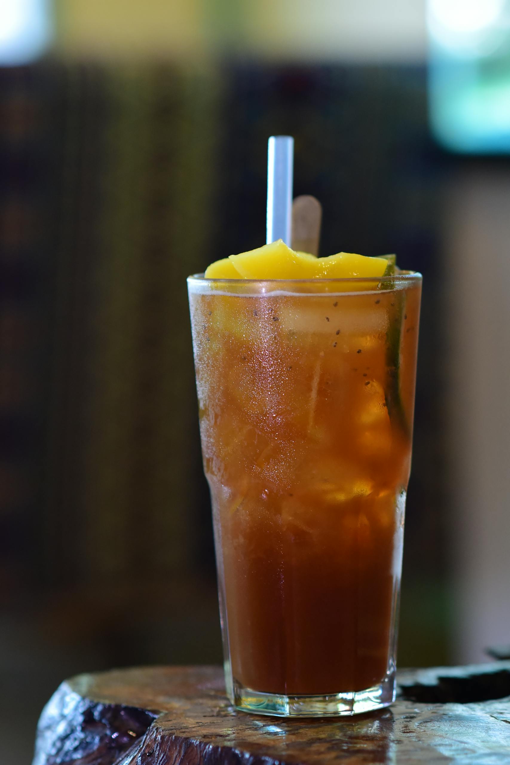 A tall glass of refreshing iced tea with a lemon garnish, ready to enjoy.
