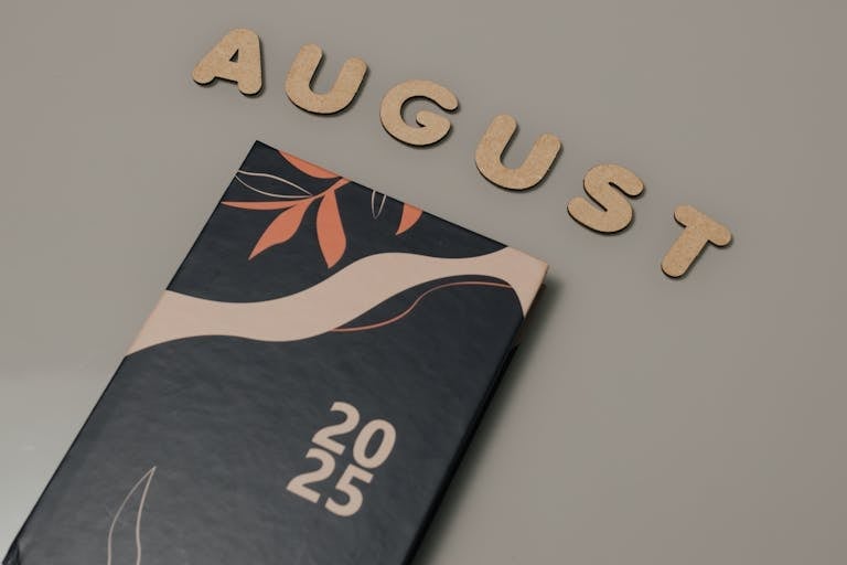 Elegant 2025 planner with decorative cover and August wooden letters.