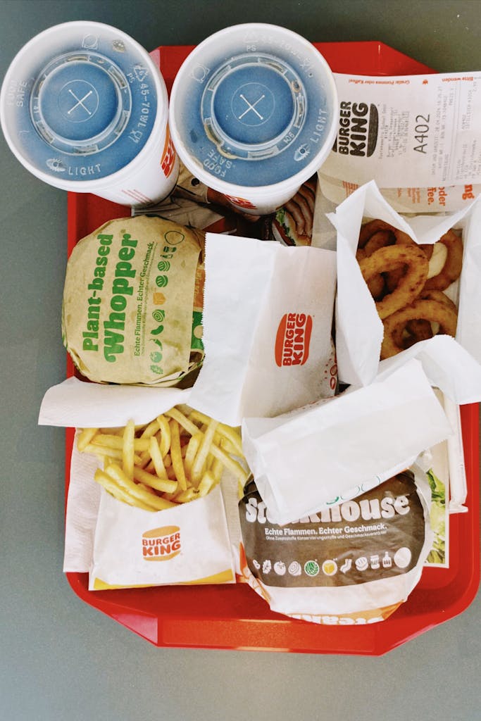 Tray of fast food with burgers, fries, and drinks served at Burger King in Hamburg, Germany.