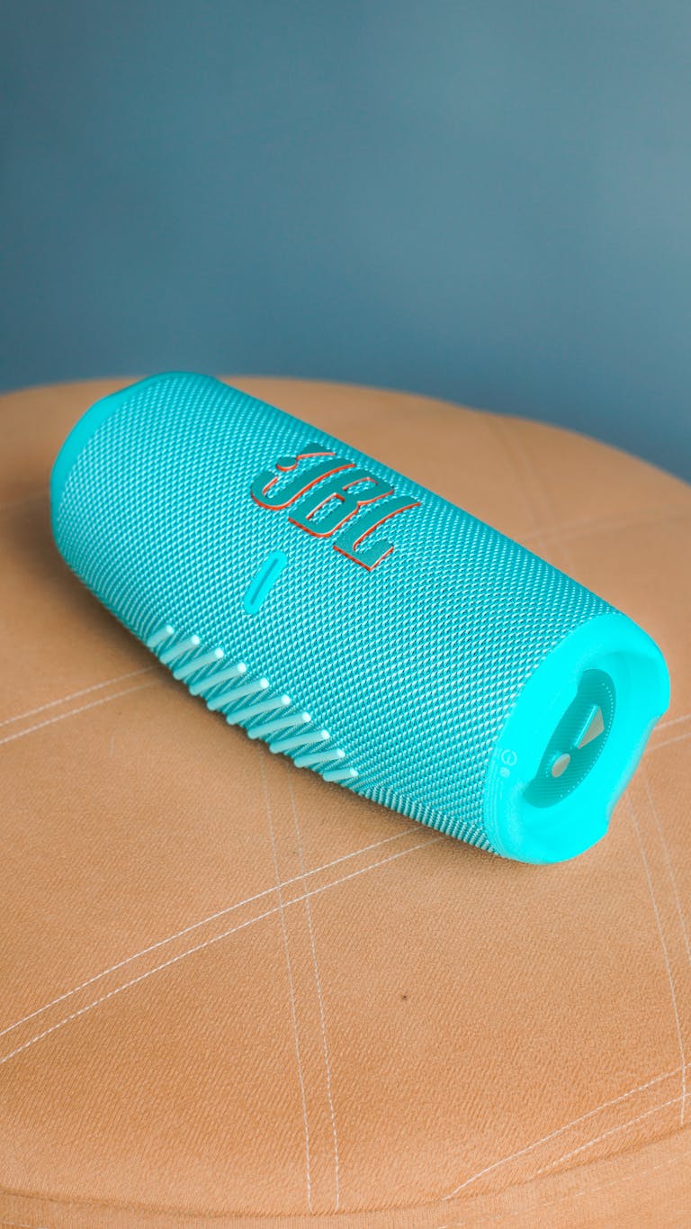 Teal JBL portable Bluetooth speaker with modern design, perfect for wireless music streaming.