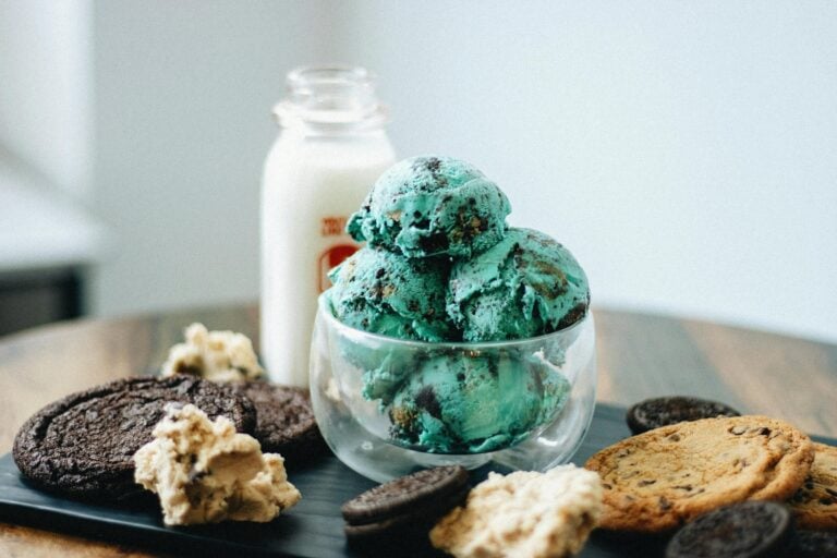 Indulge in mint chocolate chip ice cream with cookies and milk on a tray.