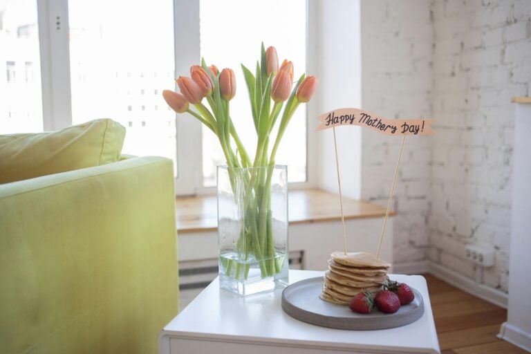 Bright and cozy Mother's Day setup with pancakes and tulips indoors.