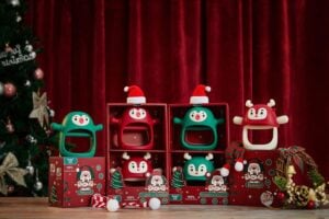 Red and green Smily Mia holiday teethers displayed by Christmas decorations