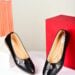 Sophisticated black women's flats on minimalist white and red background, perfect for modern fashion photography.