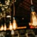 Close-up of vintage Edison bulbs hanging indoors with a warm glow, creating a cozy atmosphere.